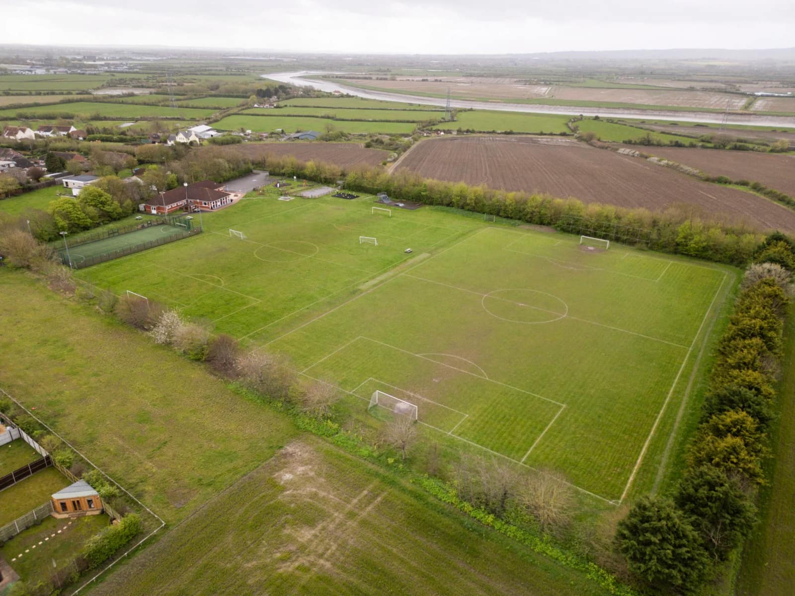 Aerial view of the pitches with the Somerset Levels stretching to the horizon