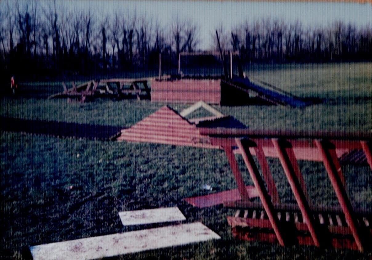 Timber frames for the first shelter laid out on the bare playing field in 1997